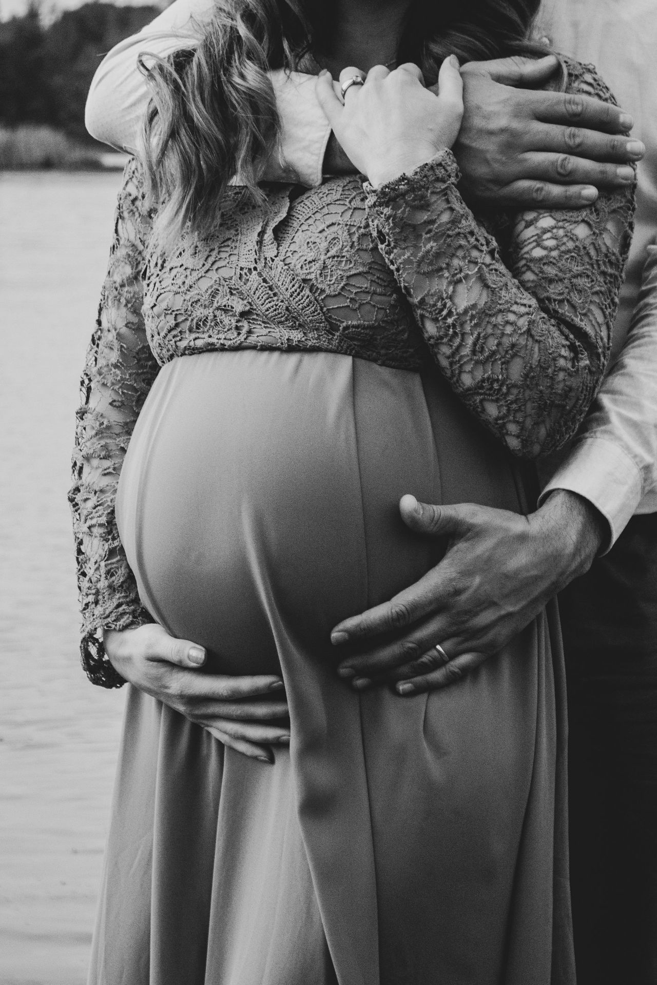 a pregnant woman is holding her husband's belly